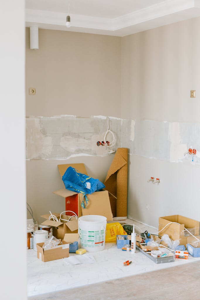 A room in the midst of home renovation with tools and supplies scattered around.